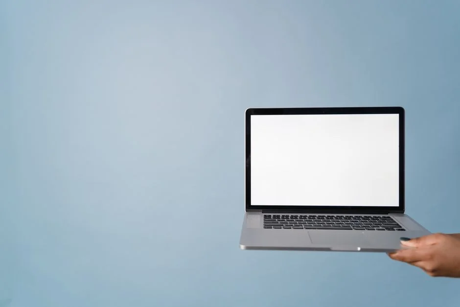 A contemporary workspace showcasing a laptop, tablet, and smartphones, ideal for tech and freelance use.