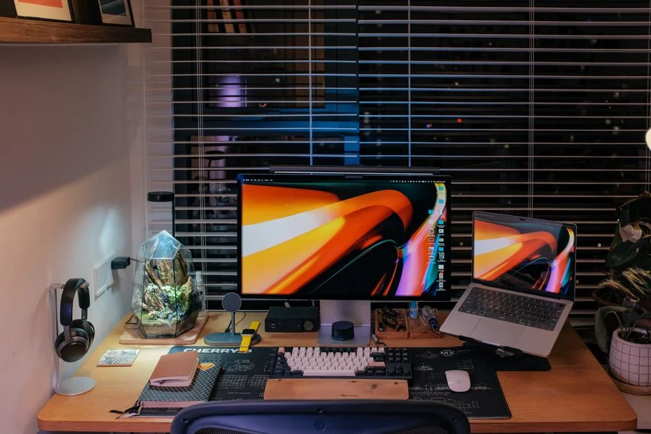A contemporary workspace with two computer monitors showing web design projects, highlighting technology and productivity.